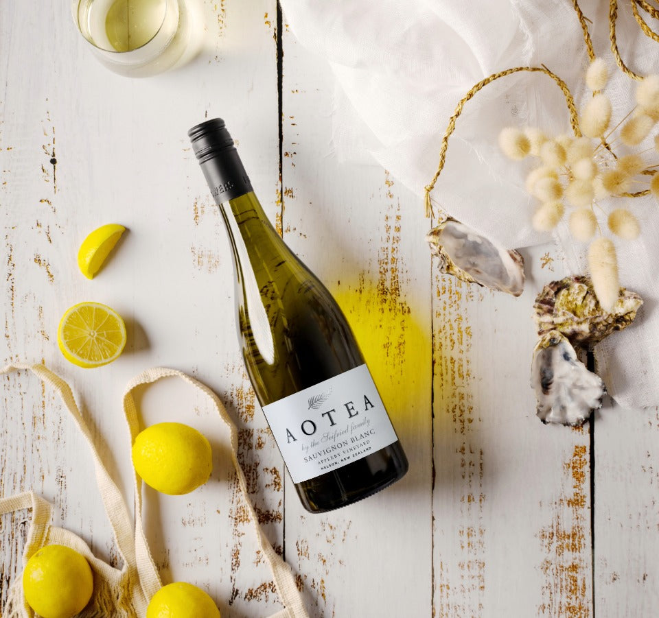 Bottle of Aotea by Seifried Nelson Sauvignon Blanc styled with fresh sliced lemons and oysters to highlight its crisp citrus flavours and seafood pairings