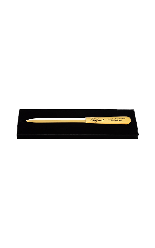 Engraved brass Seifried letter opener displayed in a black presentation box on a transparent background