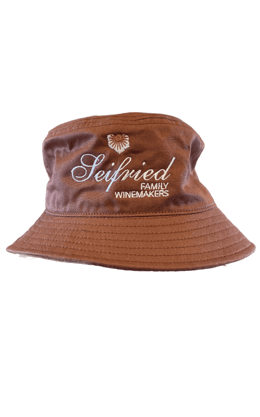 Clay brown cotton bucket hat with white embroidered Seifried Family Winemakers logo on a transparent background