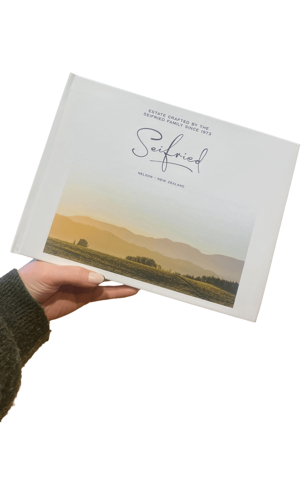 Seifried Estate 50th Anniversary photo book featuring landscape views of the Nelson vineyard