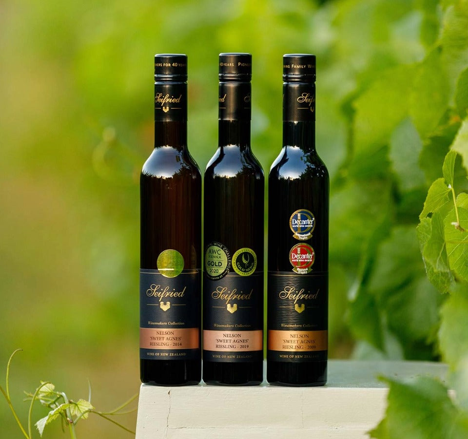 Bottles of Sweet Agnes Heritage Trio in a vineyard